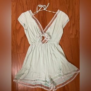 Mint green gauze romper with trim tie detail along front neckline